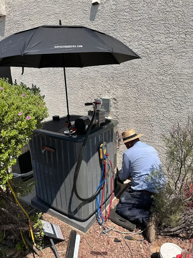 HVAC technician performing outdoor AC maintenance in Vestavia Hills