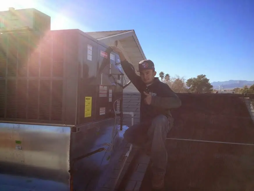 HVAC technician performing Boiler Repair on a rooftop unit in Vestavia Hills